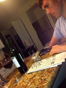 Relaxing with a glass of wine and a crossword puzzle